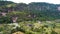 Aerial view of Minangkabau house or Rumah Gadang in a beautiful landscape view of Harau Valley with mountains valley and grass