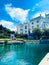 Aerial view of Miramare Castle surrounded by water under blue bright sky