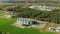 Aerial View Modern Granary, Grain-drying Complex, Commercial Grain Or Seed Silos And chicken farm In Sunny Rural