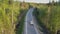 Aerial view modern highway with cars among evergreen forest