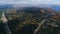 Aerial view modern road along autumn forest against lake