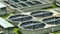 Aerial view of modern water cleaning facility at urban wastewater treatment plant. Purification process of removing