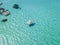 Aerial view of a moored boat floating on a transparent sea.