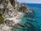 Aerial view of moored boats floating on a transparent sea. Scuba diving and summer holidays. Capo Vaticano, Calabria, Italy