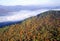 Aerial view of morning fog over mountains near Stowe, VT in autumn along Scenic Route 100