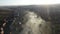 Aerial view of morning mist above a village. House roofs raising from clouds