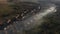 Aerial view of morning mist above a village. House roofs raising from clouds