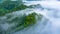 Aerial view of morning mist at tropical rainforest mountain, background of forest and mist, Aerial top view background forest