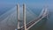 Aerial view of the most beautiful Portuguese bridge in Lisbon, Vasco da Gama. Morning foggy seascape.