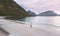 Aerial view mother walking with baby on island beach family travel