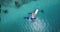 Aerial view of motorboat approaching hydroplane floating in turquoise water