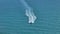 Aerial view of motorboat sailing fast on sea waves with ripple surface. Sailboat in motion on ocean in Florida
