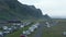 Aerial view motorhomes parked in background mossy mountain nature landscape in Iceland. Drone view motorhomes camping