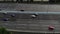 Aerial view of a motorway. Camera move slow left. A lot of cars ride on the 10 lanes motorway.