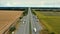 Aerial view of a motorway in summer on a cloudy day. Aerial view of a suburb road with trucks. Drone  above a highway with driving