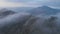 Aerial view of mount Batur and lake Batur in the evening with the evaporation of clouds.
