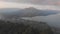 Aerial view of mount Batur and lake Batur in the evening with the evaporation of clouds.