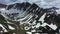 Aerial view of mountain chain on Kamchatka peninsula. Drone 4k footage, dramatic aerial view. Snowy mountains in July