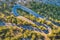 Aerial view of mountain curve road with cars, green forest