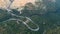 Aerial view of mountain curve road. Green forest at sunset in summer in Europe. Landscape with asphalt road, trees on the rocks.