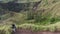 Aerial view. Mountain and green valley view. Traveling woman enjoying mountain landscape. Back view of a long-haired