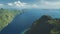 Aerial view of mountain greenery island at ocean bay on summer sunny day. Green forest highland isle