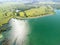 Aerial view on mountain lake. Drone over water reservoir at mountain valley covered with green spring forest. Beautiful