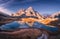 Aerial view of mountain lake with reflection at sunset in autumn