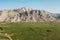 Aerial view of mountain meeting meadow with many paths