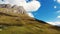 Aerial view of mountain pass, North Caucasus. Range of mountain peaks illuminates the bright sun. Slopes are covered