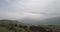 Aerial view with mountain road and heavy mist at the background