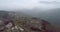 Aerial view with mountain road and heavy mist at the background