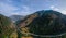 Aerial view of mountain road, mountains and a river near the town of Predazzo, Trentino, Italy consequences of bad weather,