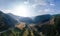 Aerial view of mountain road, mountains and a river near the town of Predazzo, Trentino, Italy consequences of bad weather,