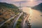 Aerial view of mountain roads and beautiful bridge at sunset