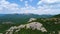 Aerial view of mountain rocks with a vast valley on blue cloudy sky background. Shot. Natural breathtaking landscape