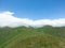 Aerial view mountain. Scenic aerial view mountain ridge. Above green landscape with sunlight mountains covered with clouds