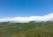 Aerial view mountain. Scenic aerial view mountain ridge. Above green landscape with sunlight mountains covered with clouds