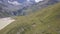 Aerial view of the mountain slope and the valley. Clip. Aerial panoramic view of stony yellow, green hill on a sunny day