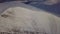 Aerial view of mountain snow-capped peak, at sunrise