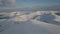 Aerial view of mountain snow-capped peak, at sunrise