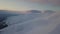 Aerial view of mountain snow-capped peak, at sunrise