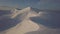 Aerial view of mountain snow-capped peak, at sunrise