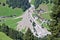 Aerial view of mountain stream in the Austrian Alps blocked after a massive mudflow with excavator and truck working to clean up