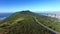 Aerial view, mountains and nature with a road through the wilderness in Cape Town, South Africa during summer. Drone