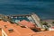 Aerial view from mountains to the main port of the island of La Gomera. Colorful roofs and houses on slope of Volcano in San