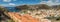 Aerial view from mountains to the main port of the island of La Gomera. Colorful roofs and houses on slope of Volcano in San