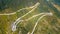 Aerial view of the movement of vehicles on a serpentine mountain road. Croatia