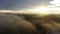 Aerial view moving above a foggy sunrise