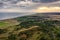 Aerial view of Muckleburgh Hill and Weybourne in Norfolk, the sun rising above Sheringham in the distance, the manmade hill in the